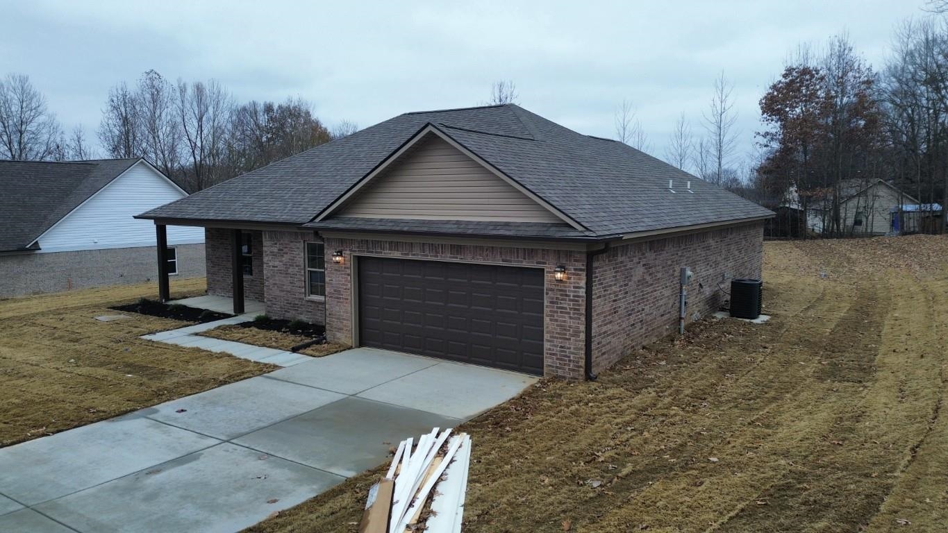 103 Stone Brook Cove Ripley, TN 38063 - Photo 2 of 8 a front view of a house with garden