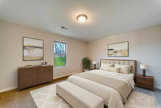 a bedroom with a bed and a window