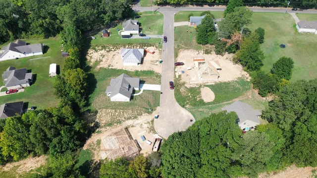 an aerial view of a house with a yard and lake view