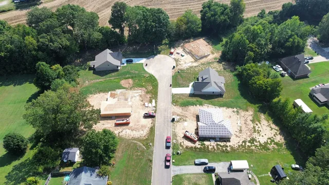 an aerial view of a house with yard swimming pool and outdoor seating
