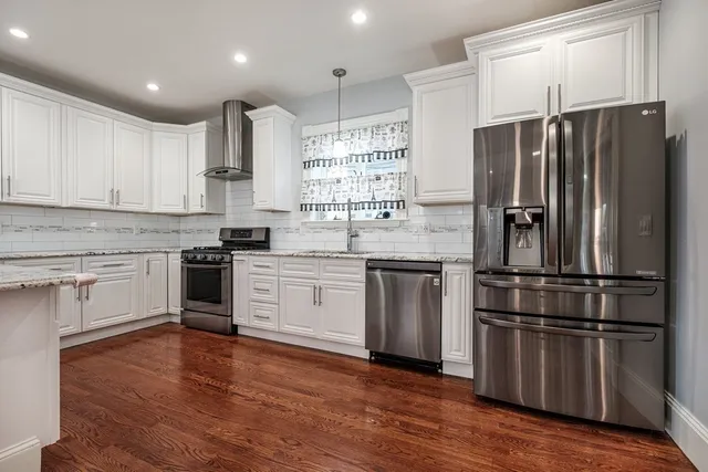 a kitchen with granite countertop stainless steel appliances a sink and counter space