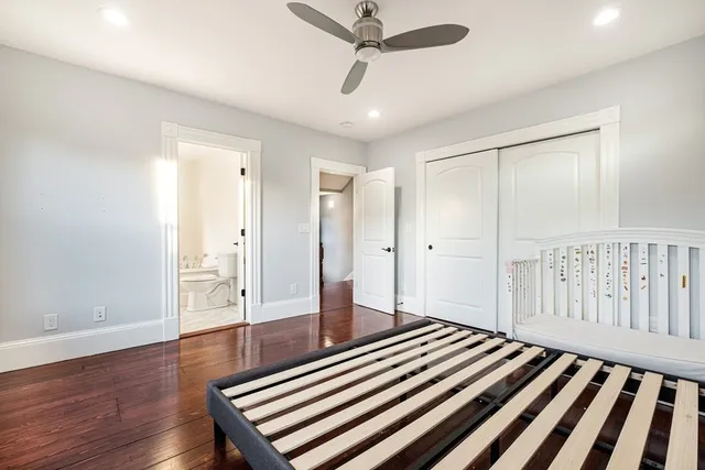 a spacious bedroom with a bed and a chandelier