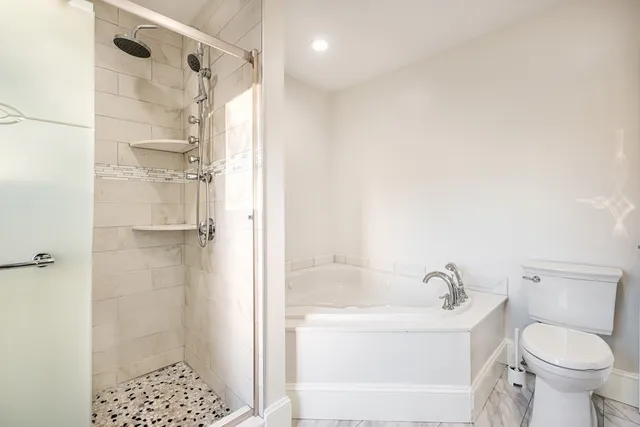 a bathroom with a bathtub and a shower