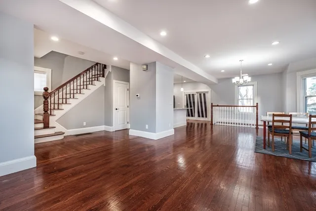a view of a room with wooden floor windows and kitchen view