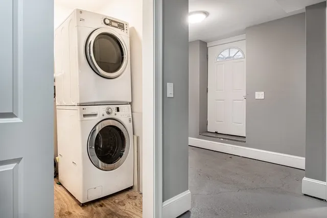 a front view of a house with a wooden deck