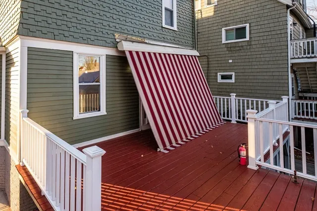 a view of backyard with deck and trees