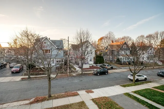 a view of a street with houses on both side