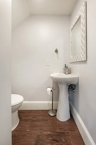 a bathroom with a sink toilet and a mirror