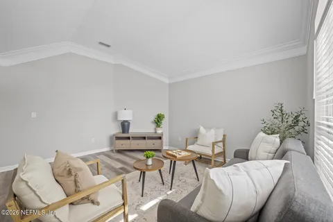 a large kitchen with kitchen island a stove a table a sink a refrigerator and a dining table