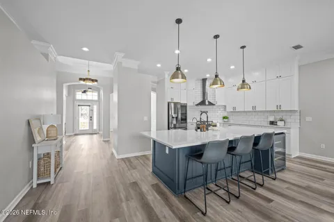 a kitchen with stainless steel appliances granite countertop a sink a stove and a refrigerator