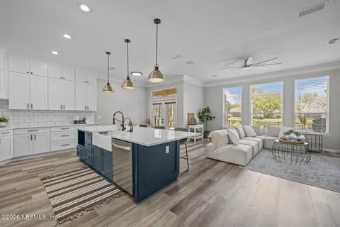 a living room with furniture a fireplace and a chandelier