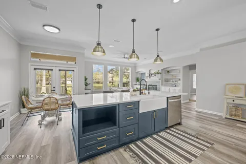 a living room with furniture and large windows