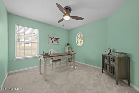 a view of a house with a big yard and large tree