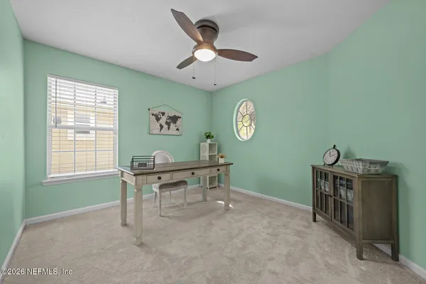 a view of a house with a big yard and large tree