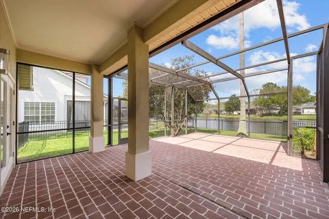 an aerial view of a swimming pool patio and yard