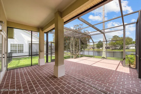 an aerial view of a swimming pool patio and yard