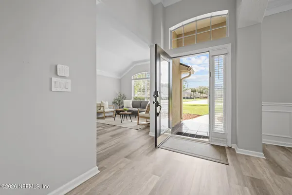 a dining room with furniture and wooden floor