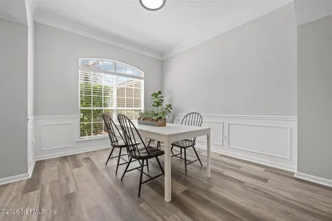 a view of a dining room with furniture and wooden floor