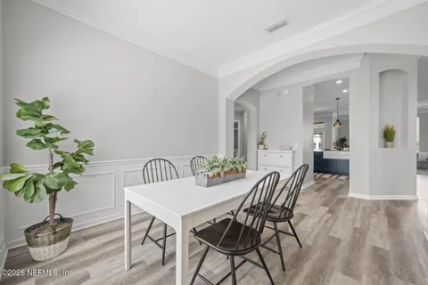 a view of a dining room with furniture and wooden floor