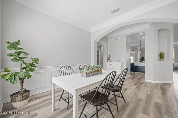a view of a dining room with furniture and wooden floor
