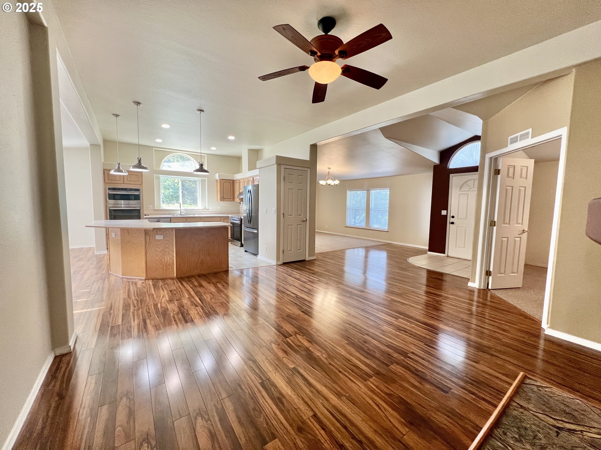 76707 Highway 207 Echo, OR 97826 - Photo 11 of 25 a view of a room with wooden floor and a kitchen