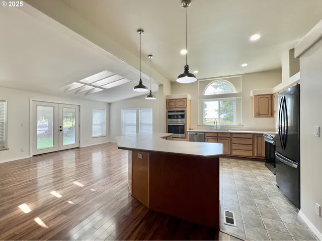 a kitchen with counter top space cabinets and appliances