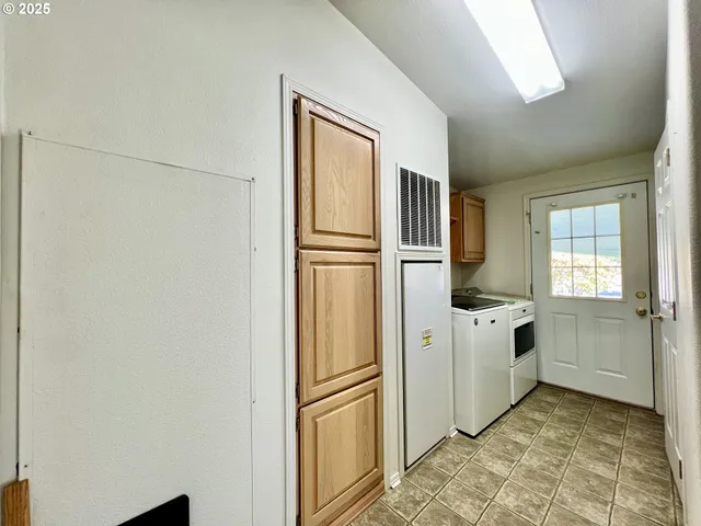 a kitchen with stainless steel appliances a refrigerator sink and cabinets