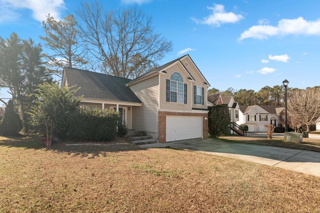 5914 Waggoner Court Rex, GA 30273 - Photo 4 of 23 a front view of a house with a yard and garage