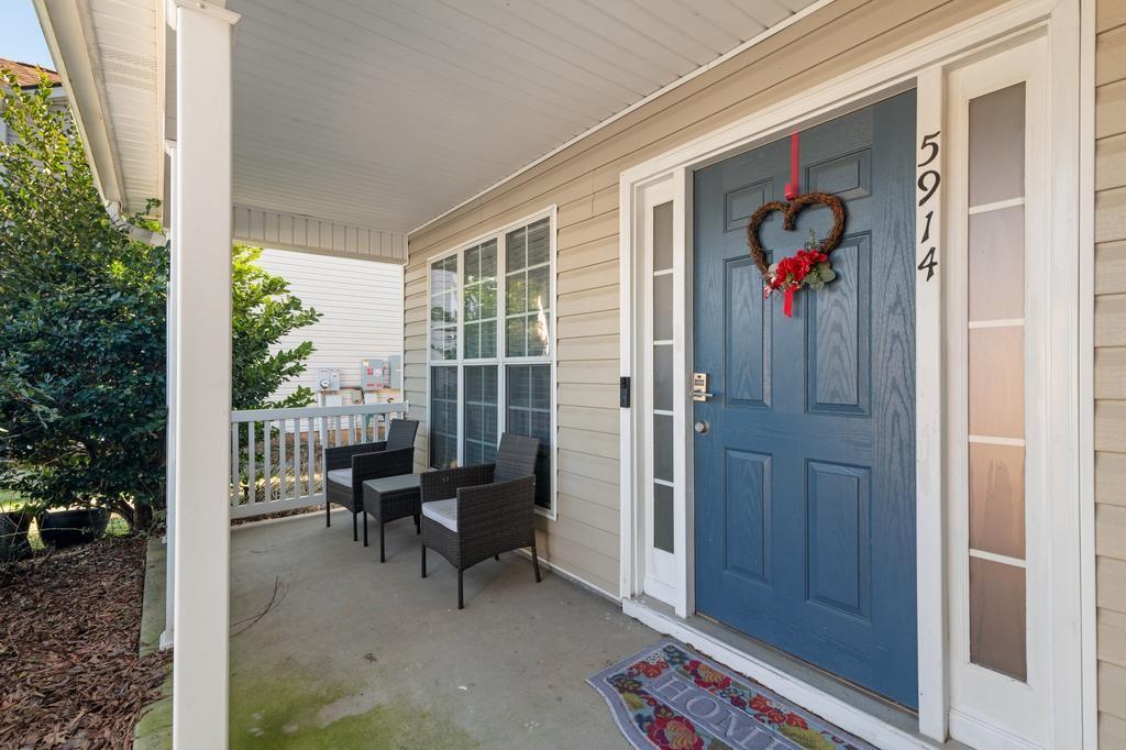 5914 Waggoner Court Rex, GA 30273 - Photo 6 of 23 a view of a porch with chairs and floor to ceiling window