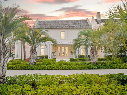 a front view of a house with a garden