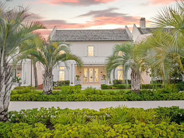 a front view of a house with a garden