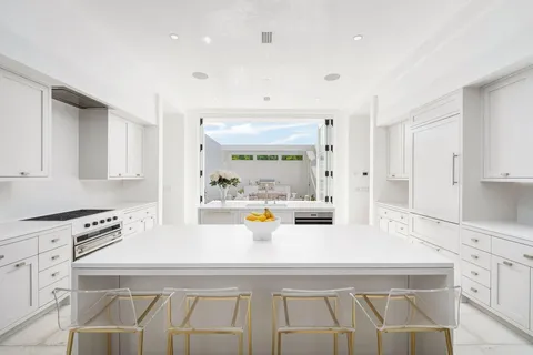 a view of kitchen with sink refrigerator and window