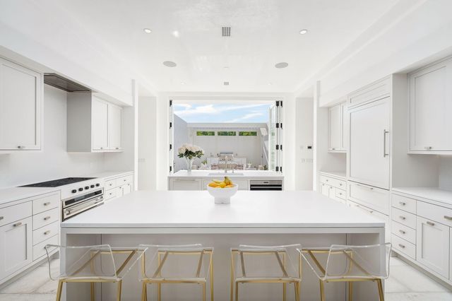 a view of kitchen with sink refrigerator and window
