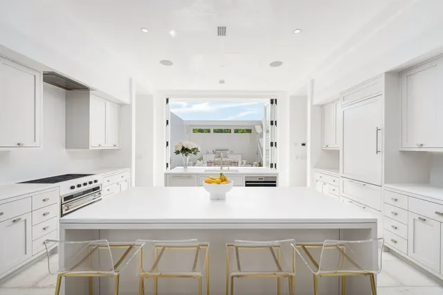 a view of kitchen with sink refrigerator and window