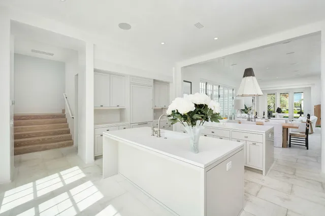 a kitchen with a sink and white cabinets