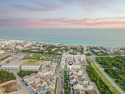 a view of a swimming pool with a yard and palm trees