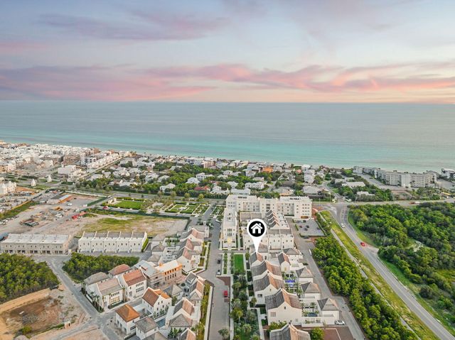 a view of a swimming pool with a yard and palm trees