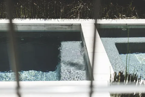a living room with furniture a large window and a chandelier