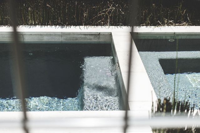a living room with furniture a large window and a chandelier