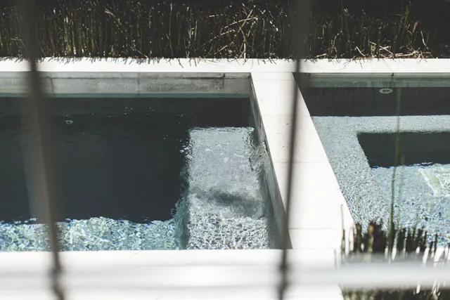 a living room with furniture a large window and a chandelier