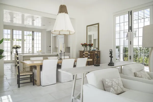 a view of a house with a yard and potted plants
