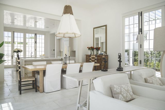 a view of a house with a yard and potted plants