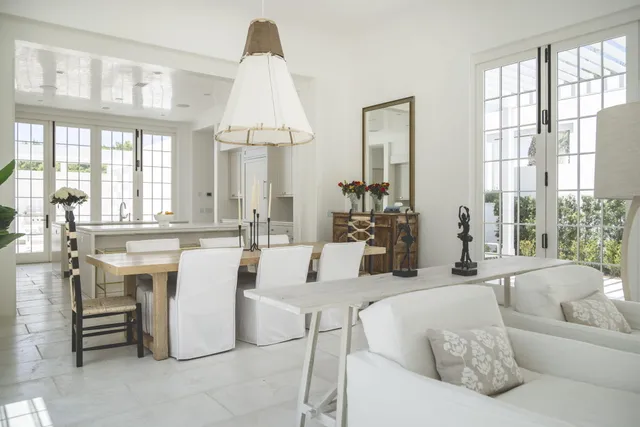 a view of a house with a yard and potted plants