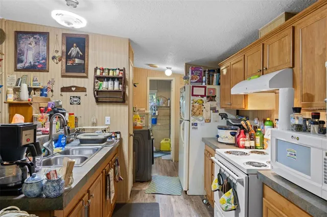 a view of a kitchen with fridge and workspace