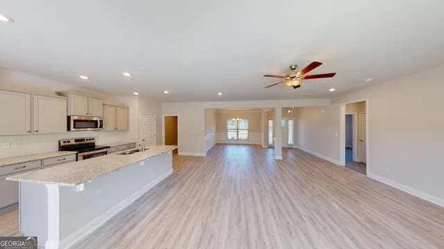 a view of a kitchen with a sink and wooden floor