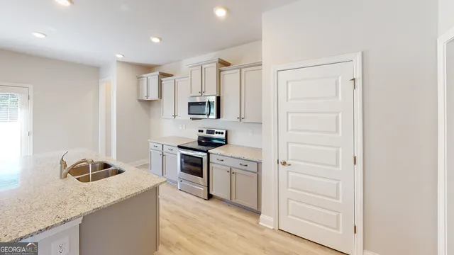 a kitchen with stainless steel appliances granite countertop a stove and a sink