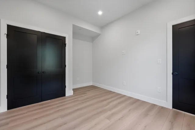a view of hallway with wooden floor