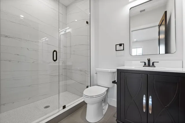 a bathroom with a bathtub shower sink mirror and toilet