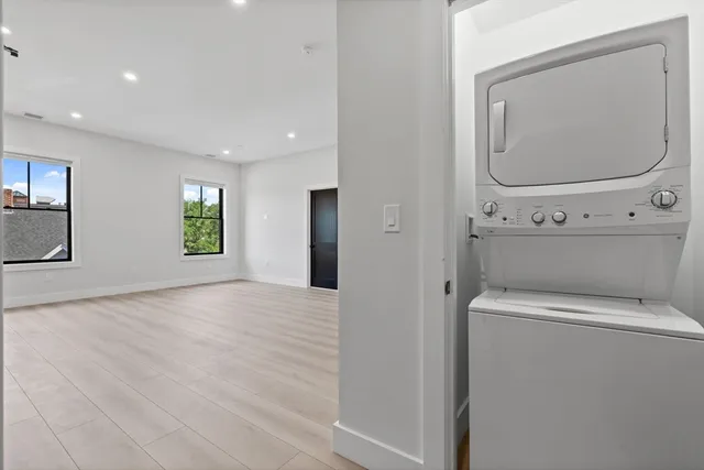 a view of a room with wooden floor and mirror