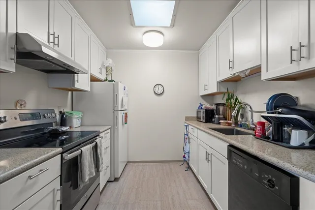 a kitchen with sink refrigerator dining table and chairs